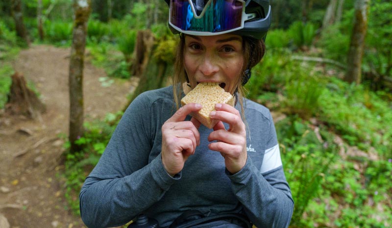 Biker eating a snack on the trail