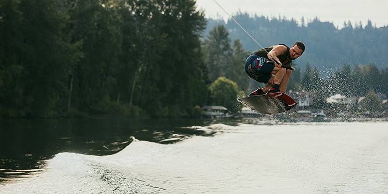 Jumping the wake on a wakeboard.