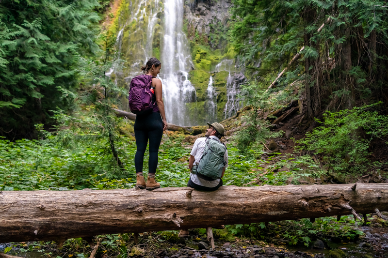 What to Pack for a Day Hike: 2 hikers enjoying a waterfall