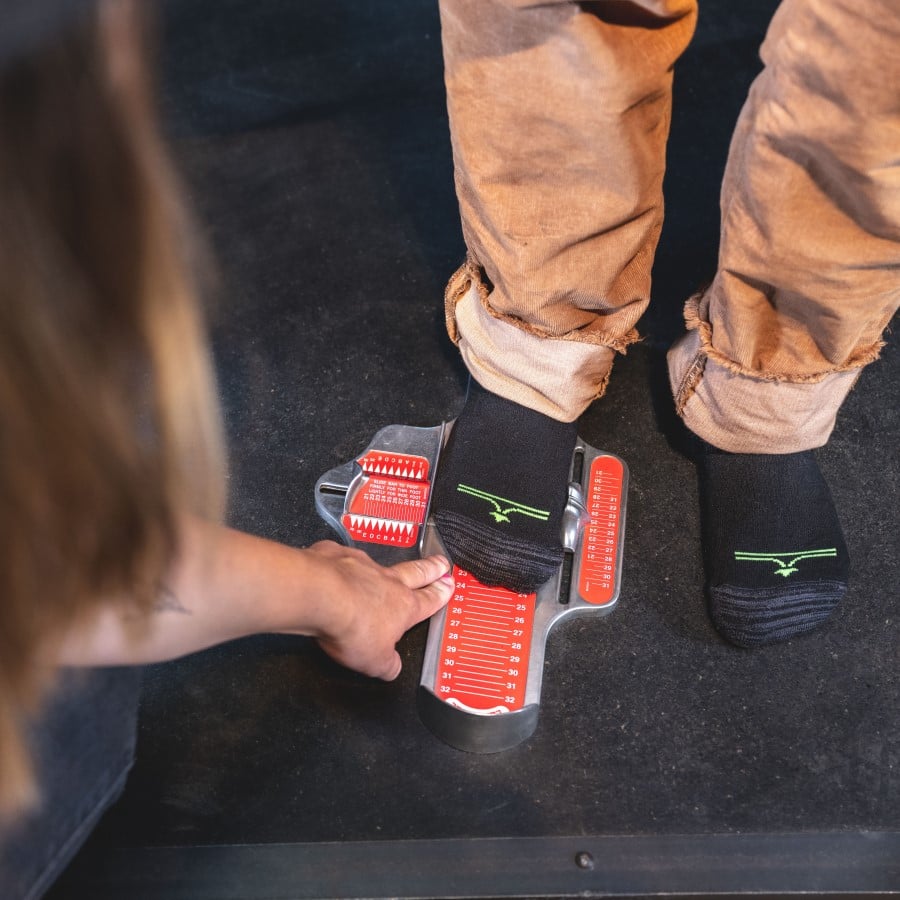 Measuring feet at evo to determine snowboard boot sizing.