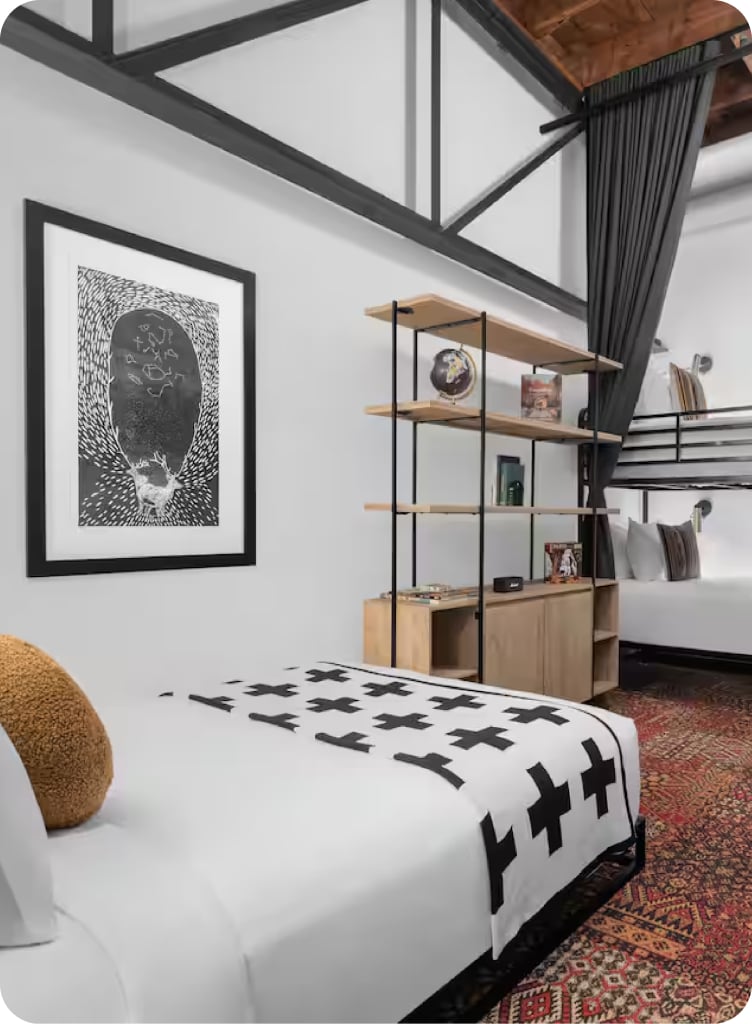 A neat hotel room with high ceilings
