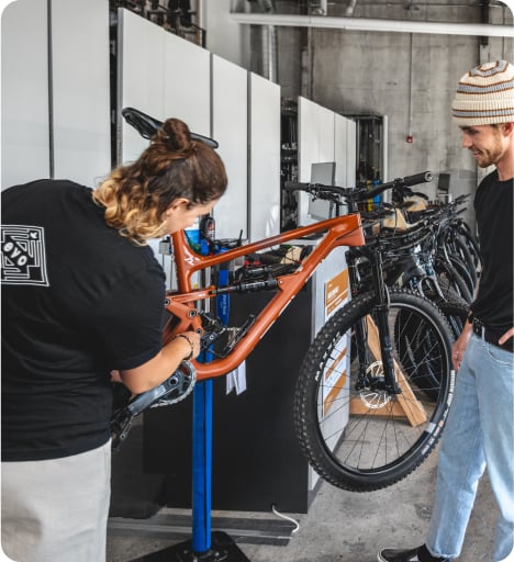 Two people inspecting a bike in a shop